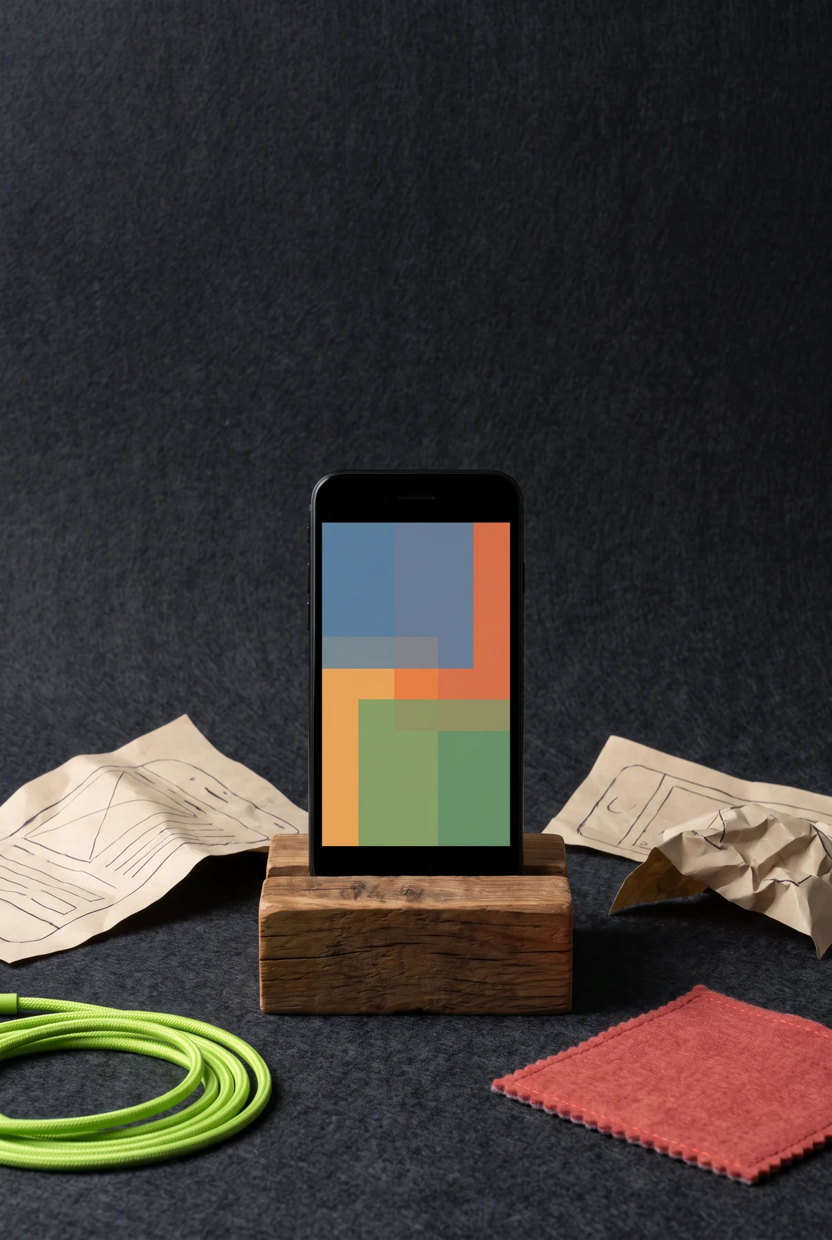 Phone prototype standing with paper planning materials